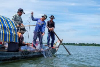 Fishers pull in nets on Tonle Sap Lake in Cambodia