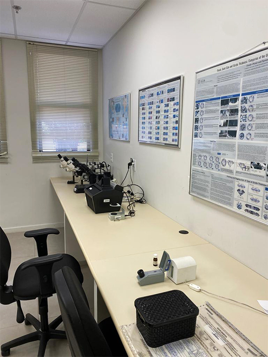 A bench with scientific equipment to analyze gold samples. 