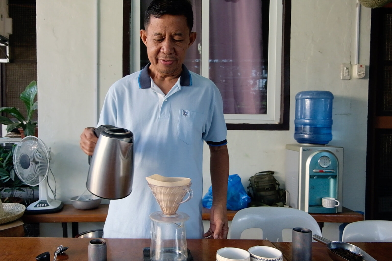 Fred Fredeluces prepares civet coffee.