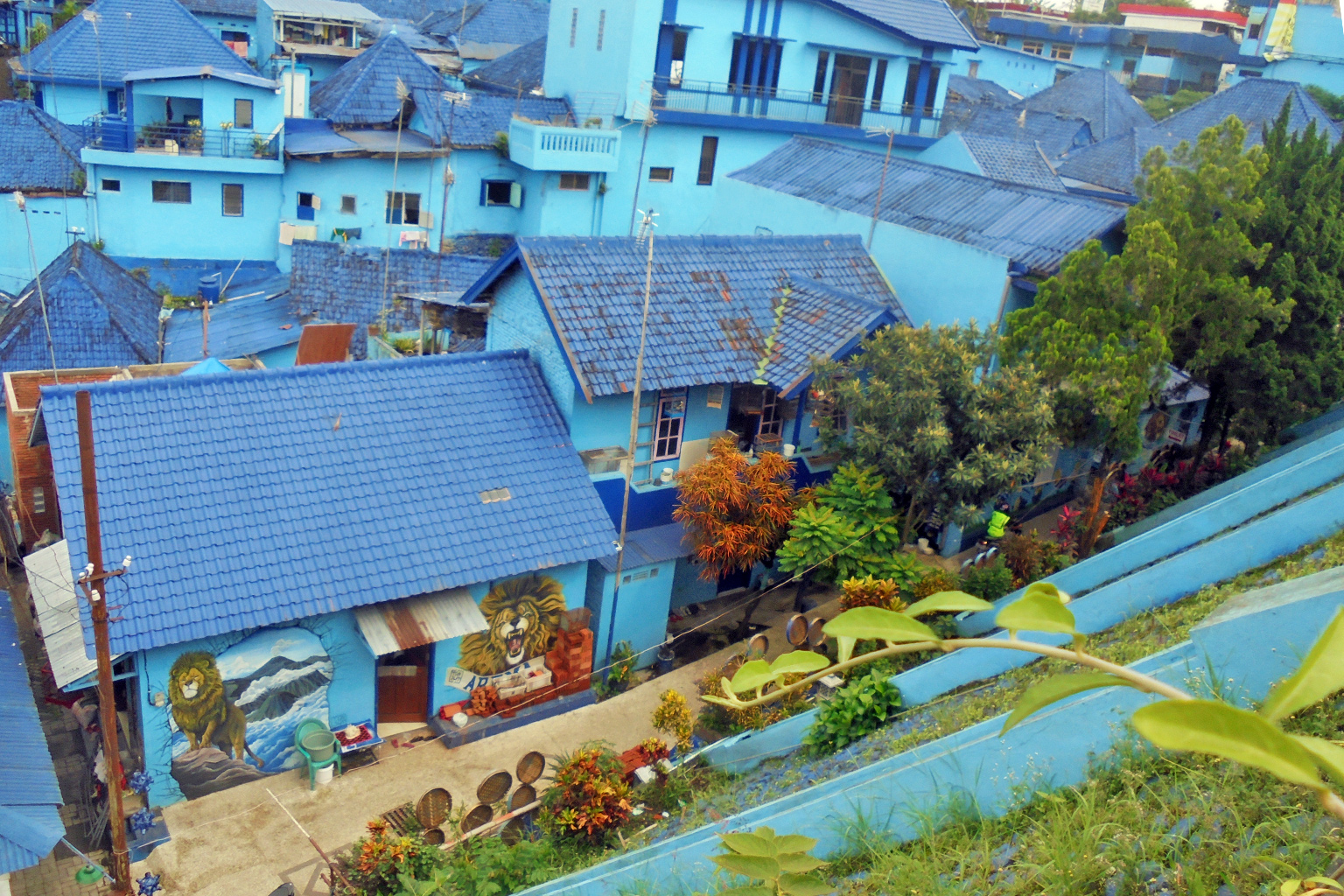 A housing settlement surrounded by trees and vegetation.