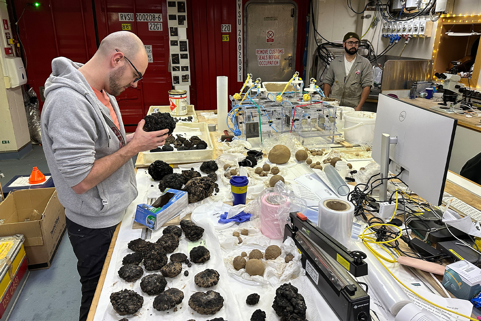 A researcher looks at the specimen collected from the deep sea.