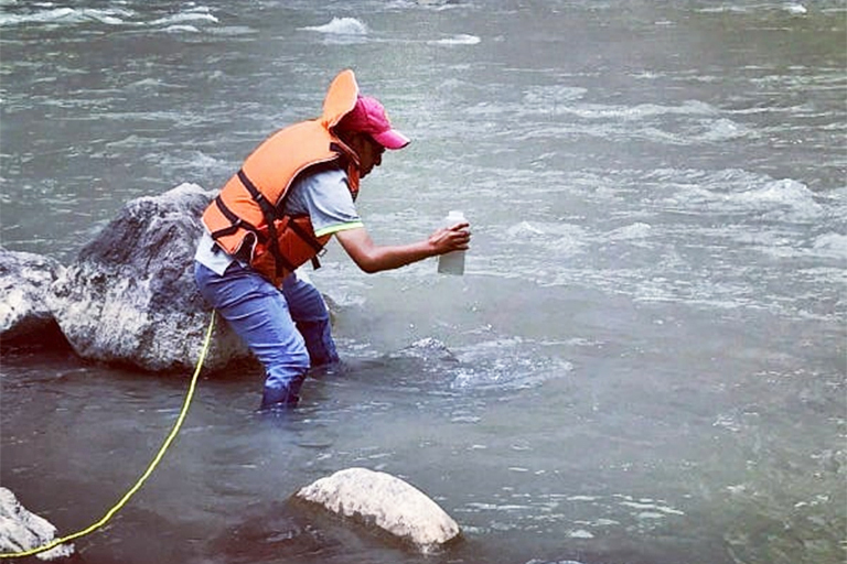 Researchers obyain eDNA by collecting scoops of water from different parts of the river.