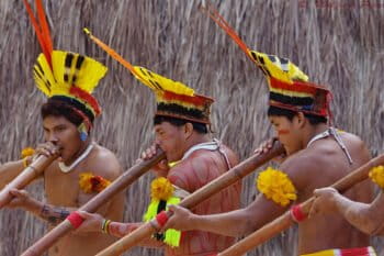 Kuikuro men playing flutes.