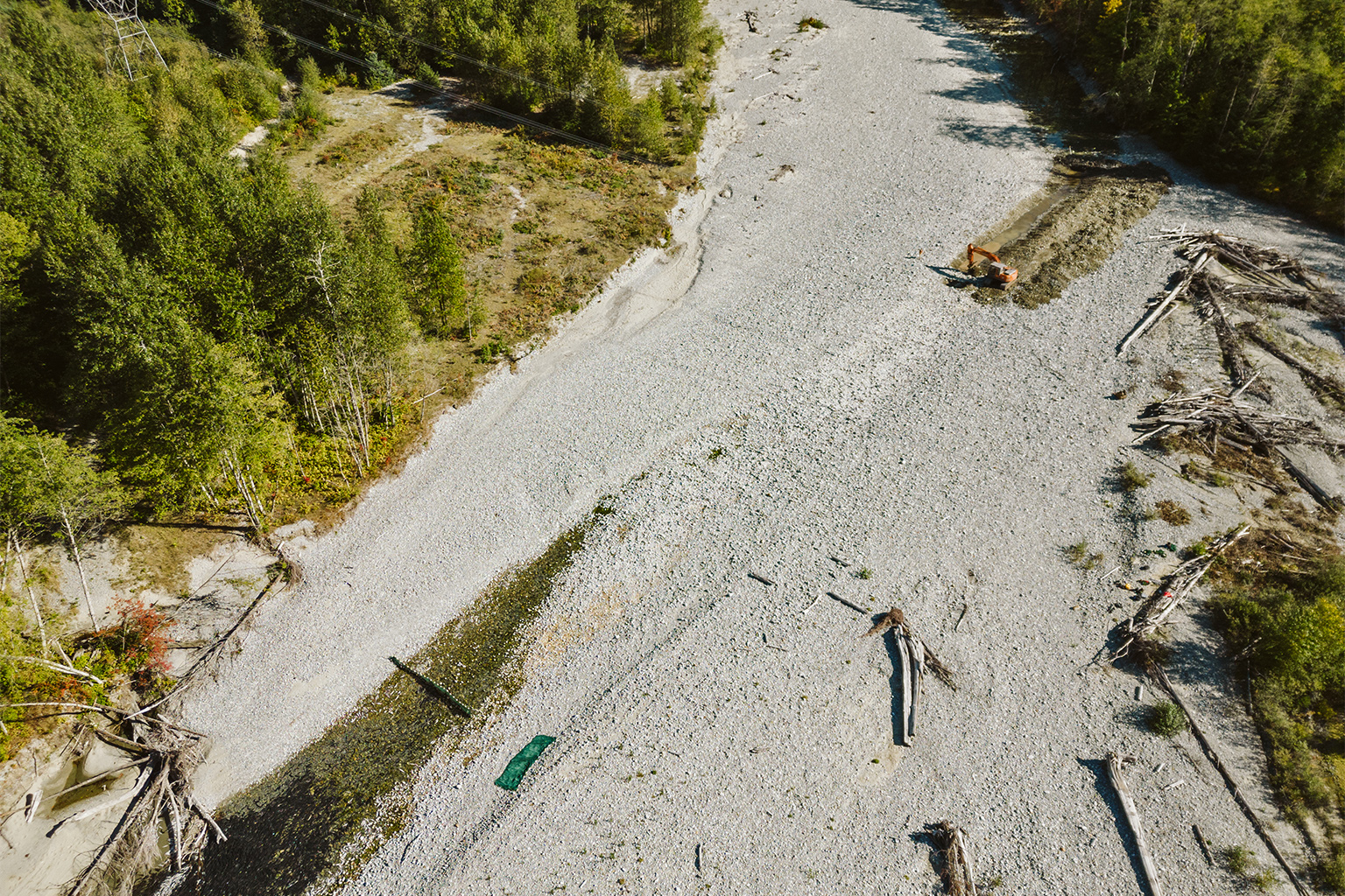 In an emergency response to the drought, an excavator is used to reestablish flow on the Indian River in southwestern British Columbia September, 2023. 