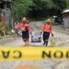 A rescue team rescuing pets after the aftermath of the landslide.