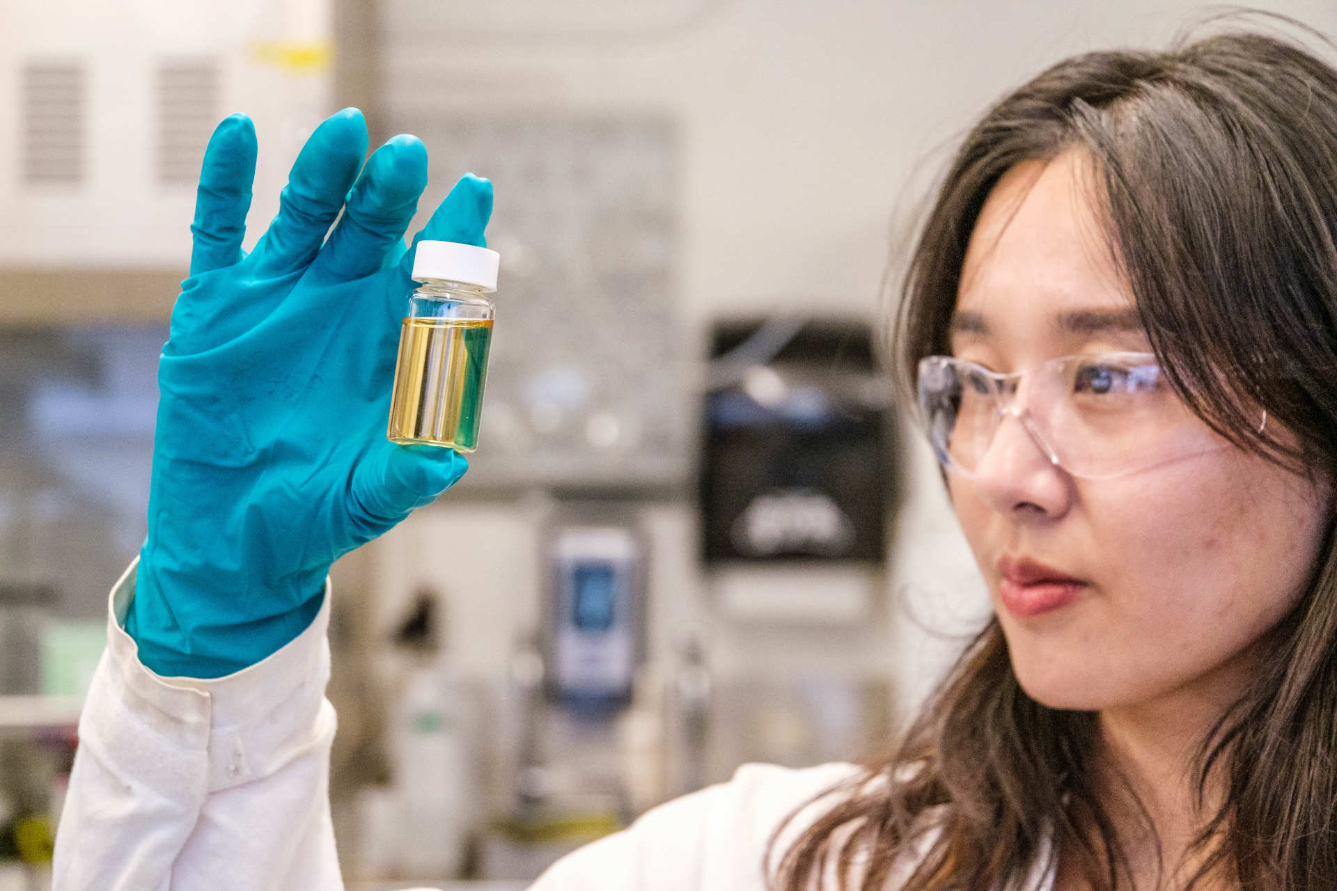 Postdoctoral researcher Tianyu Guo holds a vial of the plant polyphenol used in the bioCap filter. 