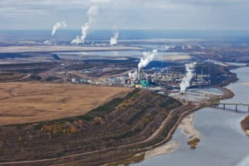 Oil refinery smokestacks along the Athabasca River, in northern Alberta, Canada.