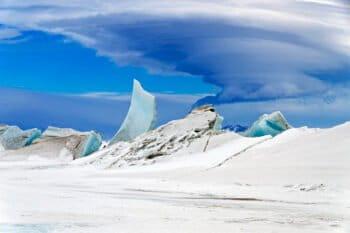 A multilayered lenticular cloud hovers near Mount Discovery, a volcano about 70 km (44 mi) southwest of McMurdo Station in Antarctica.