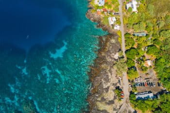 Coral reefs seen along the coast in an aerial photo.