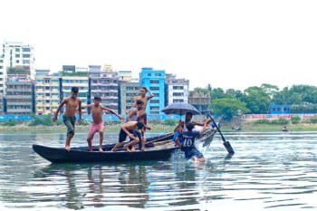 Boys swim in the Buriganga River near Dhaka during a heat wave in May 2024.