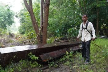 Ouk Mao showed reporters timber cut from the Phnom Chum Rok Sat community forest by loggers working for Lin Vatey. Image by Nehru Pry / Mongabay