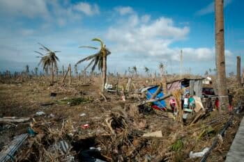The image shows the devastation of Super Typhoon Haiyan in Eastern Visayas, with many houses, agricultural lands and coconut trees destroyed.