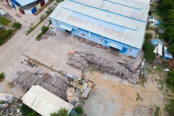 In June 2024, stacks of timber were seen piled outside Angkor Plywood's facility in Kandal province. Much of it is believed to be sourced from Cambodia's protected areas. Image by Gerald Flynn / Mongabay.