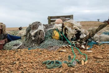 Nets, ropes, buoys and other bits of fishing equipment bursting out of decaying bags.