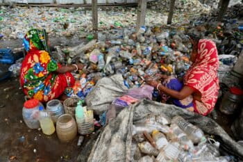 Workers sort through discared plastic in Bangladesh.