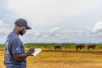 A Save The Elephants researcher studies elephants at Lake Jipe in Kenya. Image courtesy of Wildlife Conservation Network.