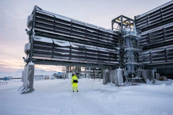 A Climeworks employee stands next to the company’s Mammoth facility in Iceland.