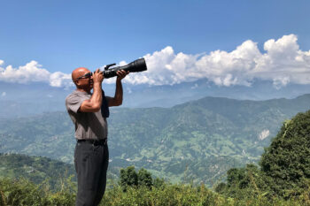 Babu Krishna Karki with his camera photographing wildlife.