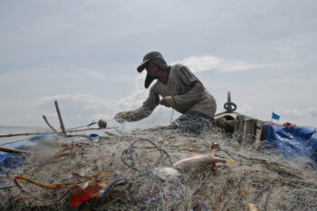 Zulkifli Dalimunthe pulls in the net he cast the previous morning.