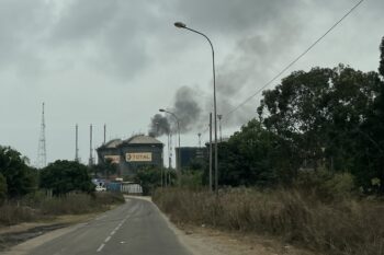 Total Energies Plant in Djeno. Behind one can see the smoke rising from the flares. Image by Elodie Toto for Mongabay.