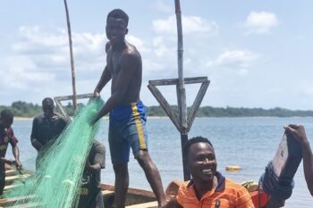Fishermen in Marshall, Liberia, prepare nets for fishing. Image by Edward Blamo for Mongabay.