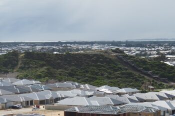 Banner image of a housing estate in Australia by Calistemon via Wikimedia Commons (CC BY-SA 4.0).