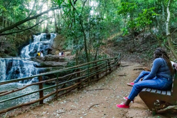 Two people sit in conversation on a bench beside a path along a stream in Karurua forest, Nairobi, Kenya. https://www.flickr.com/photos/ninara/51944328733/ https://creativecommons.org/licenses/by/2.0/