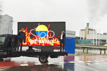 Dutch forest advocates Maarten Visschers and Fenna Swart (right) protest the burning of forest biomass for energy outside Vattenfall's headquarters in Amsterdam in 2021.