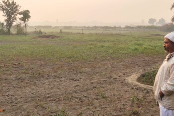 Banner image of farmer Khem Raj Nepal from Sarlahi, Nepal, looking at his farm. Image by Mukesh Pokhrel.