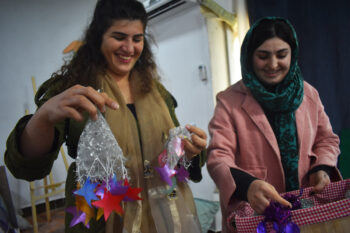 Zozan Basin Shekho (left)and Suzan Haskani (right) show the decorations crafted from discarded plastic, giving the waste a new life and purpose.