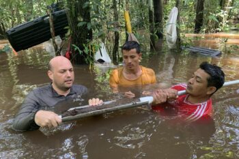 Members of the international study team pull a peat core from a wetland in the Colombian Amazon.