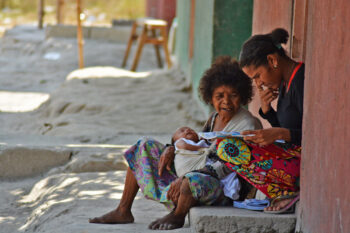 Aeta women read a book.