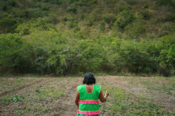 Sueli Maxakali in front of a reforested hill. Image by Xavier Bartaburu/Mongabay.