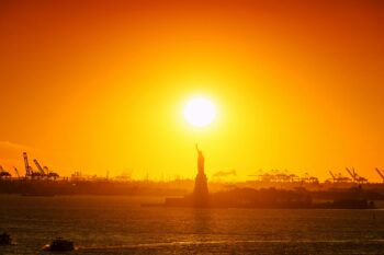 The sun sets New York City. Lengthy record-setting heat waves can be costly, greatly increasing ozone and other air pollutants, resulting in deaths and hospitalizations, while also straining energy grids, transportation networks and water supplies. Image by Johannes Plenio (@jplenio) via Unsplash.