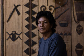 Dami Tateburuk sits in the Malinggai Uma Tradisional Mentawai house.