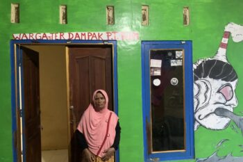 Sarmi, a resident of Gupit village, Nguter district, who is a representative of residents in a class action lawsuit against PT. RUM, which caused pollution. Her house was decorated with murals in solidarity as a sign of the residents' struggle.