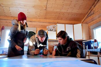 Chrystal Mantyka-Pringle leading cultural mapping exercises with Tr'ondek Hwech'in First Nation citizens Ryan Petersen and Zack Everitt at the community’s Land of Plenty cultural camp in 2019. Image courtesy of Elaine Cordon.