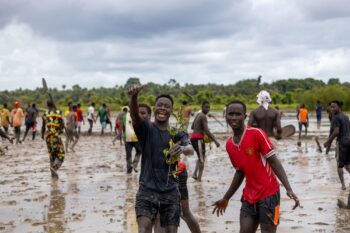 Residents of the village of Baraca gather at a mangrove restoration site.