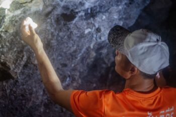 Sakda Khayankitphuanphon took reporters into the old mining tunnels to see the fluorite that Universal Mining seeks to extract from the mountains. Image by Gerald Flynn / Mongabay.