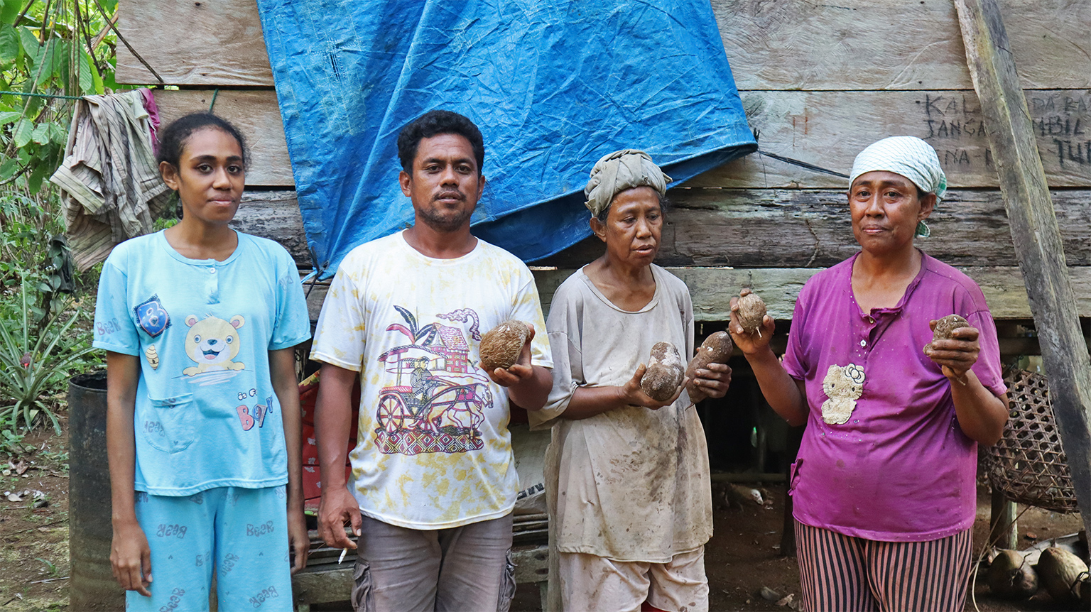 Deslin Kalaeng and her family pose with Banggai yams.