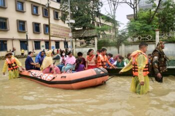 Rescuers evacuate people from a flooded hospital following landslides and flash flooding in India's northeast state of Manipur, Sunday, June 1, 2025. (AP Photo/Donald Sairem)