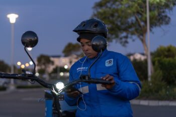 Siphe Mlawuli getting ready to deliver an order in the Cape Town suburb of Parklands. Image by Barry Christianson for Mongabay.