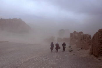 Students in Afghanistan walk to school in a sand storm during a drought in 2019.
