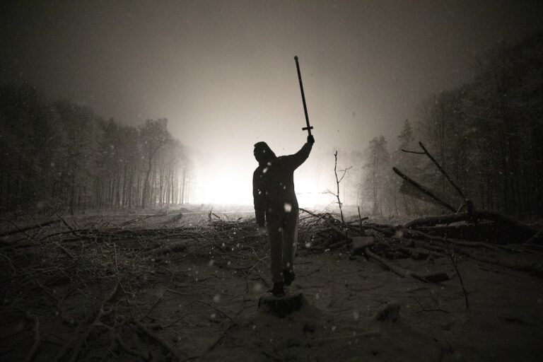 Activist holding a stick aloft during the occupation of Dannenroder Forest in Germany, to prevent construction of a new highway. Image courtesy of Alberto Mazzieri / Climate Visuals Countdown.