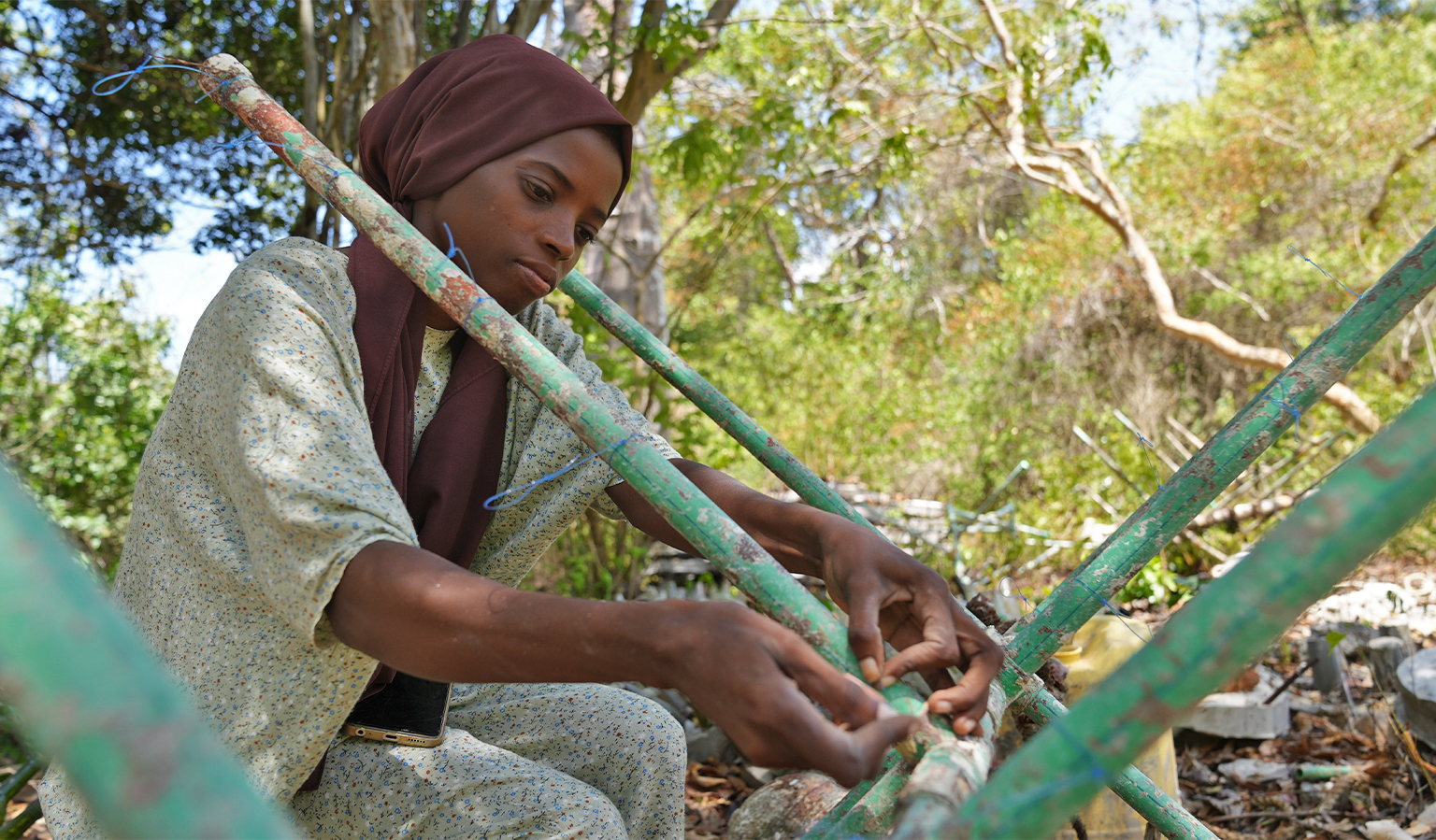 A worker prepares an artificial reef structure at the REEFolution compound in Shimoni.