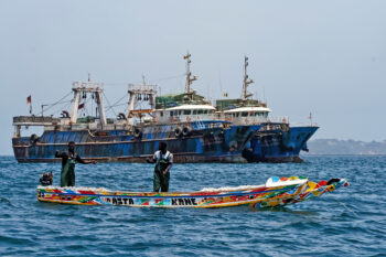 Industrial trawlers and small-scale fishers compete for space near the port of Dakar in Senegal.