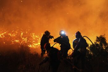 Firefighters battle with a large wildfire burning in Kofinas, on the eastern Aegean island of Chios, Greece, late Sunday, June 22, 2025. (Pantelis Fykaris/Politischios.gr via AP)
