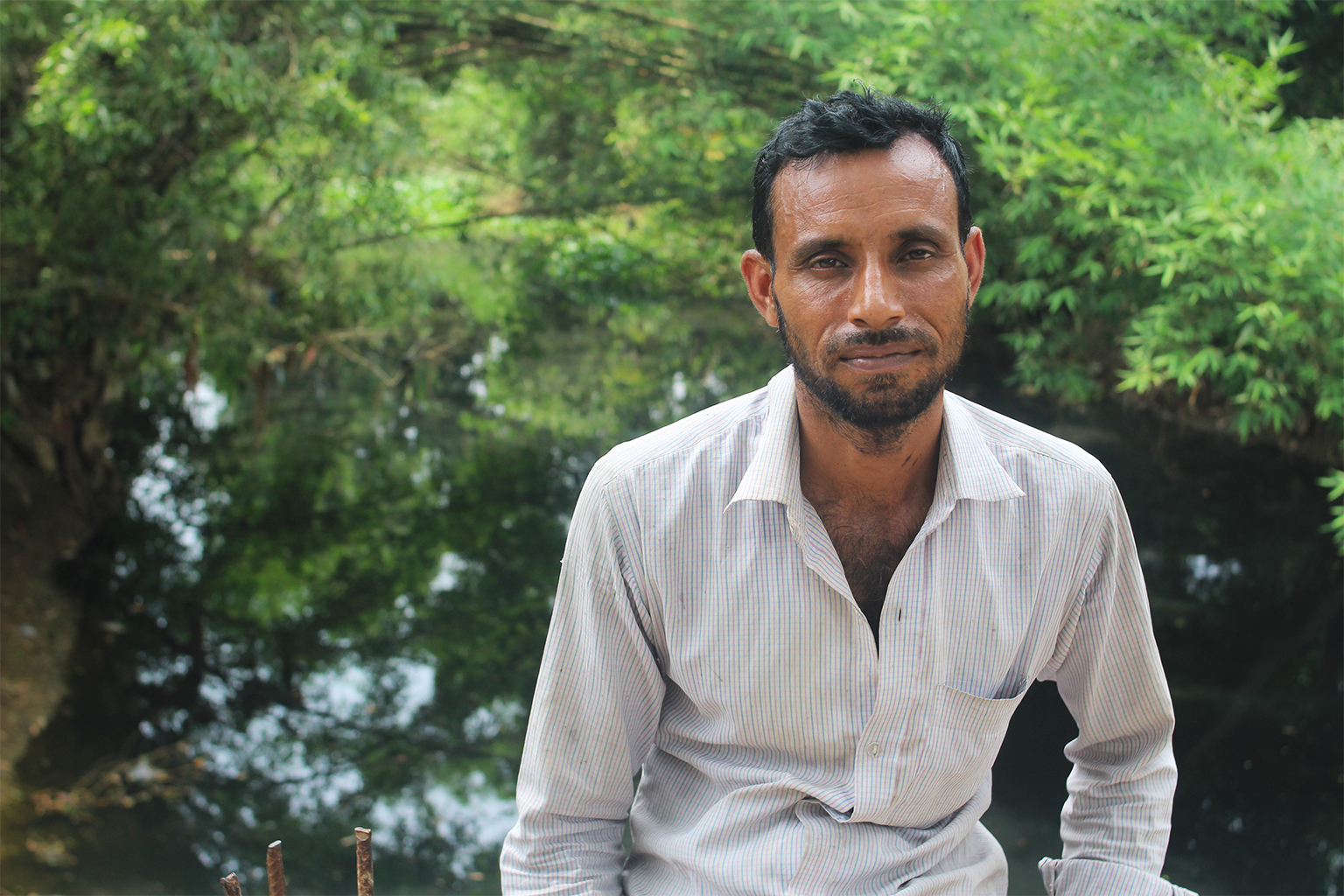 Farmer Zahed Chowdhury cultivates his rice crop on his small land adjacent to the Katakhal in Abdullahpur village.