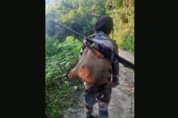 A hunter in Nagaland with a gun and barking deer. Image courtesy of Satem Longchar.