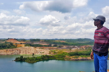 Rukka shows the location of a former coal mine pit that flows into the Nangka River, which is now polluted.